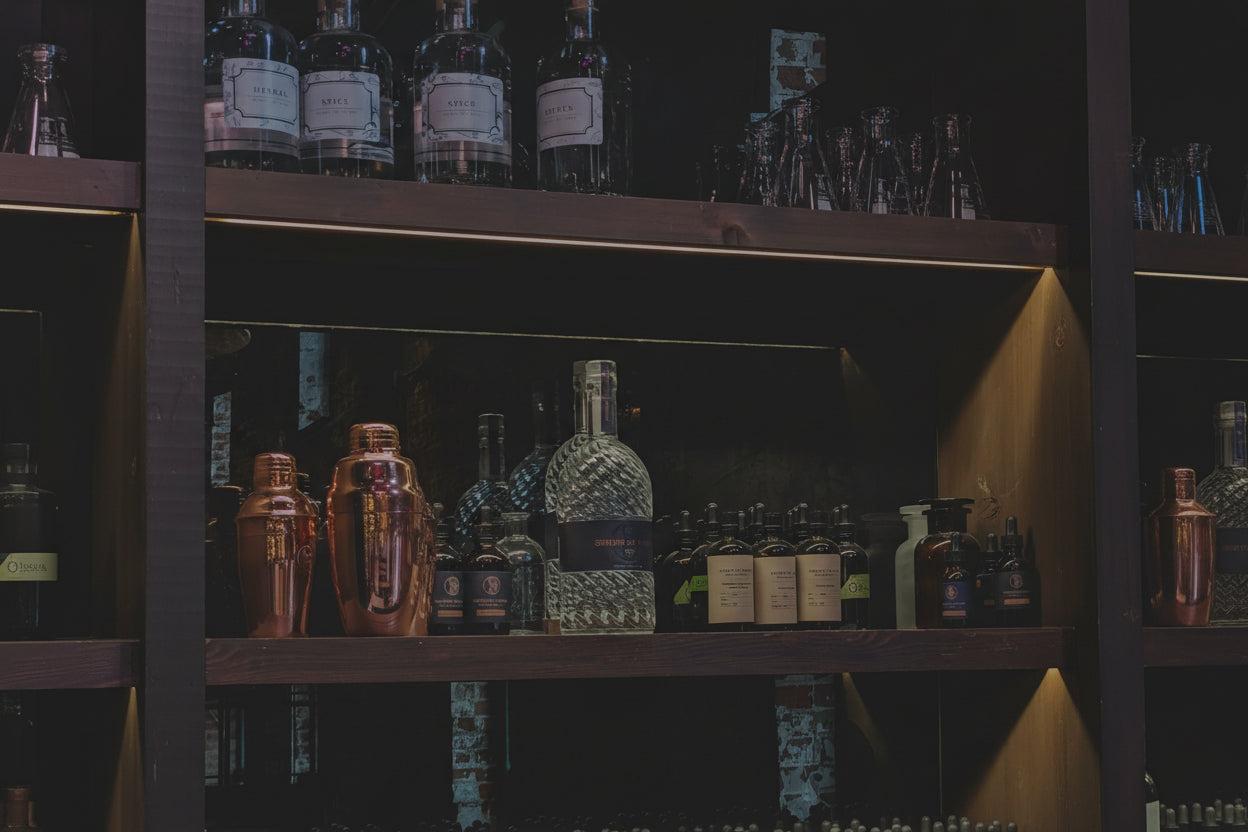 Wooden shelves with various bottles and jars on a dark background